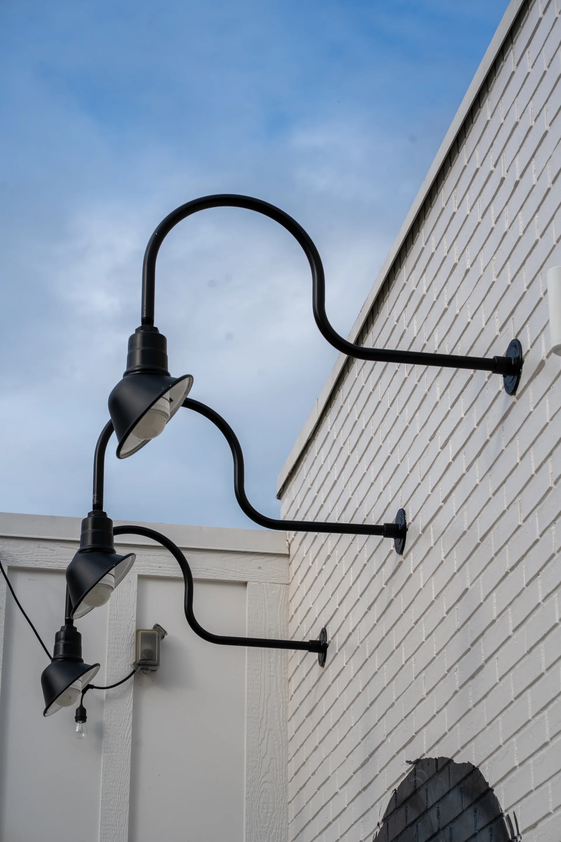RLM certified gooseneck wall lights on commercial building exterior