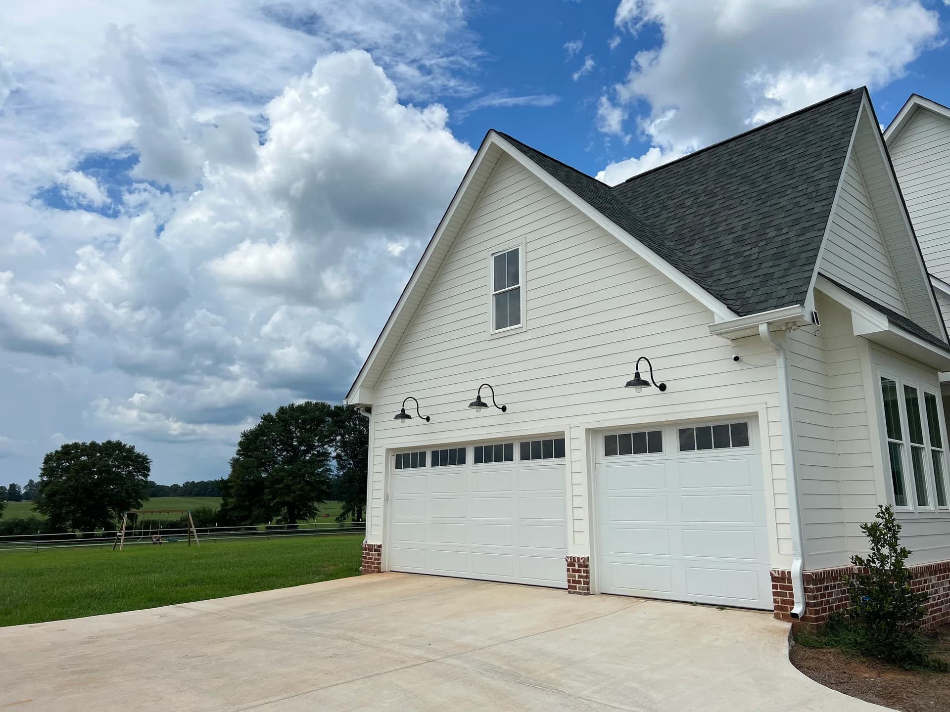 RLM certified gooseneck lights on residential garage exterior